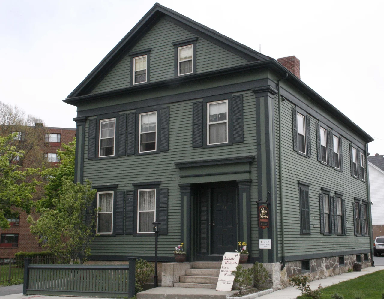 Erected in 1845, the home was originally a two family and was later made into a single family by Andrew J. Borden. 
Andrew J. Borden bought the house at 92 Second Street to be close to his bank and various downtown businesses. The Bed &amp; Breakfast is named after Andrew J. Borden’s youngest daughter, Lizzie. Although she was tried and acquitted of the murders she was ostracized by the community of Fall River. 


Lizzie Borden and the murders....Lizzie Andrew Borden (July 19, 1860 – June 1, 1927) was a New England spinster who was the only suspect for the hatchet murders of her father and stepmother on August 4, 1892 in Fall River, Massachusetts. The murders, subsequent trial, and following trial by media became a cause célèbre. The fame of the incident has endured in American pop culture and criminology. Although Lizzie Borden was acquitted, she was at the time (and is to an extent today) widely believed to be guilty: no one else was ever arrested or tried, and she has remained notorious in American folklore. Dispute over the identity of the killer or killers continues to this day.
During the morning of August 4, 1892, Borden's father, Andrew Jackson Borden, and her stepmother, Abby Durfee Borden, were murdered in the family home. The only other people present at the residence at the time were Lizzie and the family maid, Bridget Sullivan. Emma Borden, Lizzie's sister, was away from home. The Borden sisters' uncle, John Vinnicum Morse, brother of Andrew Borden's first wife, was visiting at the time, but was also away from the house during the time of the murders.
That day, Andrew Borden had gone into town to do his usual rounds at the bank and post office. He returned home at about 10:45 a.m. About a half-hour later, Lizzie Borden found his body. According to Sullivan's testimony, she was lying down in her room on the third floor of the house shortly after 11:00 a.m. when she heard Lizzie call to her, saying someone had killed her father, whose body was found slumped on a couch in the downstairs sitting room. Andrew Borden's face was turned to the right hand side, apparently at ease as if he were asleep.
Shortly thereafter, while Lizzie Borden was being tended by neighbors and the family doctor, Sullivan discovered the body of Mrs. Borden upstairs in the guest bedroom. Mr. and Mrs. Borden had both been killed by blows from a hatchet, which in the case of Andrew Borden, not only crushed his skull but cleanly split his left eyeball.
Over a period of years after the death of the first Mrs. Borden, life at 92 Second Street had grown unpleasant in many ways, and affection between the older and younger family members had waned considerably if any was present at all. The upstairs floor of the house was divided. The front was the territory of the Borden sisters, while the rear was for Mr. and Mrs. Borden. Meals were not always eaten together. Conflict had increased between the two daughters and their father about his decision to divide valuable property among relatives before his death. Relatives of their stepmother had been given a house, and John Morse, brother to the deceased Sarah Borden (the mother of the Borden daughters), had come to visit that week. His visit was to facilitate transfer of farm property, which included what had been a summer home for the Borden daughters. Shortly before the murders, a major argument had occurred which resulted in both sisters leaving home on extended "vacations". Lizzie Borden, however, decided to end her trip and returned early.
She was refused the purchase of prussic acid (hydrogen cyanide) by local druggist Eli Bence, which she claimed was for cleaning a seal skin coat.
Shortly before the murders, the entire household became violently ill. As Mr. Borden was not a popular man in town, Mrs. Borden feared they were being poisoned, but the family doctor diagnosed it as bad food.
Lizzie Borden was arrested on August 11, 1892, with her trial beginning ten months later in New Bedford, Massachusetts. Her stories proved to be inconsistent, and her behavior suspect. She was tried for the murders, defended by former Massachusetts Governor George D. Robinson and Andrew V. Jennings. One of the prosecutors in the trial was William H. Moody, future United States Attorney General and Associate Justice of the U.S. Supreme Court.
During the police investigation, a hatchet was found in the basement and was assumed to be the murder weapon. Though it was clean, most of its handle was missing and the prosecution stated that it had been broken off because it was covered with blood. However, police officer Michael Mullaly stated that he found it next to a hatchet handle. Deputy Marshall John Fleet contradicted this testimony. Later a forensics expert said there was no time for the hatchet to be cleaned after the murder. The prosecution was hampered by the fact that the Fall River police did not put credence in the new forensic technology of fingerprinting, and refused to take prints on the hatchet.
No blood-soaked clothing was found as evidence by police. A few days after the murder, Borden tore apart and burned a light blue Bedford cord cotton dress in the kitchen stove, claiming she had brushed against fresh baseboard paint which had smeared on it.
Despite incriminating circumstances, Lizzie Borden was acquitted by a jury after an hour and a half's deliberation. The fact that no murder weapon was found and no blood evidence was noted just a few minutes after the second murder pointed to reasonable doubt. Her entire original inquest testimony was barred from the trial. Also excluded was testimony regarding her attempt to purchase prussic acid. Adding to the doubt was another axe murder in the area, perpetrated by José Correira, which took place shortly before the trial. While many details were similar, Correira was not in the country when the Borden murder took place.
After the trial Borden and her sister moved to a new house called Maplecroft.[5] In June 1905, the two argued over a party Lizzie gave for Nance O'Neil and a group of actors. Shortly after that, Emma moved out of the house, and Lizzie Borden began using the name "Lizbeth A. Borden".
Lizzie Borden died of pneumonia on June 1, 1927 in Fall River, Massachusetts. The funeral details were not made public and few people attended her burial. Borden was buried in Oak Grove Cemetery under the name "Lizbeth Andrew Borden", her footstone reading "Lizbeth". Her will, probated on June 25, 1927, left $30,000 to the Fall River Animal Rescue League. She also left $500 in perpetual trust for the care of her father's grave. Nine days later, her estranged sister, Emma Lenora Borden, died from a fall in Newmarket, New Hampshire, on June 10, 1927.
The house on Second Street where the murders occurred is now a bed and breakfast. Maplecroft, the mansion Borden bought after her acquittal, on then-fashionable French Street in the "highlands" is privately owned, and only occasionally available for touring.
Several theories have been presented over the years suggesting Lizzie Borden may not have committed the murders, and that other suspects may have had possible motives. One theory is that the maid, Bridget Sullivan, did it; possibly out of outrage for being asked to clean the windows, a taxing job on a hot day, just a day after having suffered from food poisoning.  Another potential culprit was forwarded by Arnold R. Brown in his work, Lizzie Borden: The Legend, The Truth, The Final Chapter, in which Brown theorizes that the true culprit was an illegitimate paternal half-brother named William Borden, as a revenge killing in his failed efforts to extort money from his father.
Yet another theory is that Borden suffered petit mal epileptic seizures during her menstrual cycle, at which times she entered a dream-like state, and unknowingly committed the murders.
The book Lizzie by Evan Hunter posed the theory that Lizzie Borden had an affair with the actress Nance O'Neil, whom she met in Boston in 1904. In the early 20th century, it was still considered socially unacceptable for women to become actresses. O'Neil was a spendthrift, always in financial trouble, and Borden came from a wealthy background. The two got along, despite Borden's notoriety.
While there has never been any significant evidence that the two were intimate, the friendship was cited as the cause of Borden's final separation from her sister, Emma. O'Neil was later a character in the musical about Lizzie Borden, entitled Lizzie Borden: A Musical Tragedy in Two Axe, where she was played by Suellen Vance. Feminist Carolyn Gage refers to O'Neil as an overt lesbian, and although there are few documented details of any affairs, Gage claimed that her sexual orientation was well known in entertainment circles, despite her marriage.
The trial received a tremendous amount of national publicity. It has been compared to the later trials of Bruno Hauptmann, Ethel and Julius Rosenberg and O.J. Simpson as a landmark in media coverage of legal proceedings.
The case was memorialized in a popular jump-rope rhyme:
Lizzie Borden took an axe 
And gave her mother forty whacks. 
When she saw what she had done 
She gave her father forty-one. 
The anonymous rhyme was made up by a writer as an alluring little tune to sell newspapers even though in reality her stepmother suffered 18 or 19 blows, her father 11. Though acquitted for the crimes, Lizzie Borden was ostracized by neighbors following the trial.

Lizzie Borden's name was again brought to the public forefront when she was accused of shoplifting in 1897.

Genealogy
Borden was distantly related to the American milk processor Gail Borden (1801–1874) and Robert Borden (1854–1937), Canada's Prime Minister during World War I.

Elizabeth Montgomery and Lizzie Borden were sixth cousins once removed, both descending from 17th-century Massachusetts resident John Luther. Rhonda McClure, the genealogist who documented the Montgomery-Borden connection, said, "I wonder how Elizabeth would have felt if she knew she was playing her own cousin.
